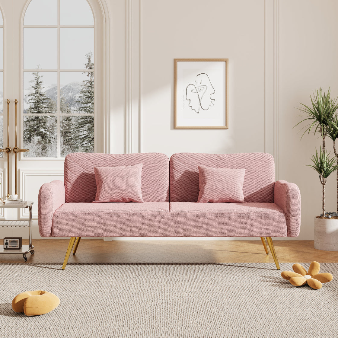 Pink sofa in a modern living room with decorative elements.