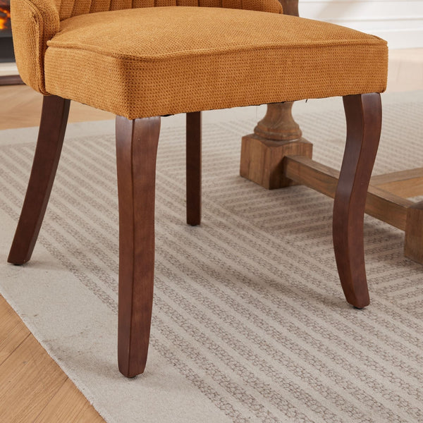 Leg detail of the Set of 2 Rayon Cloth Flocking Linen Dining Chairs featuring curved dark wood legs on a patterned rug.