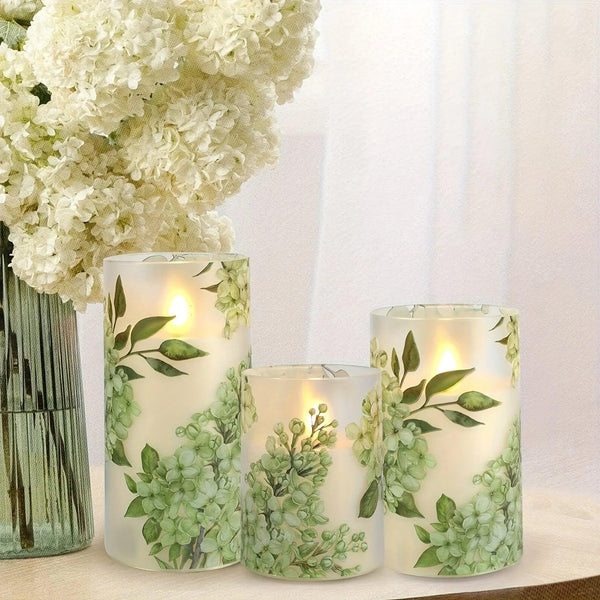 A set of 3 flameless candles, flickering LED pillar candles, with a 10-button remote control. They feature a green floral theme, are suitable for spring and summer, and can be used on the dining tables at wedding venues