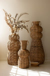SET OF THREE WOVEN SEAGRASS AND IRON FLOOR VASES