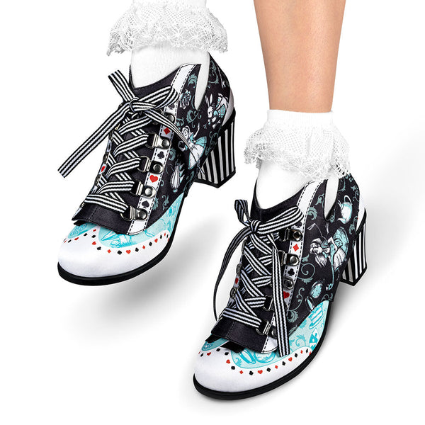 Pair of black and white patterned shoes with high heels on a white background