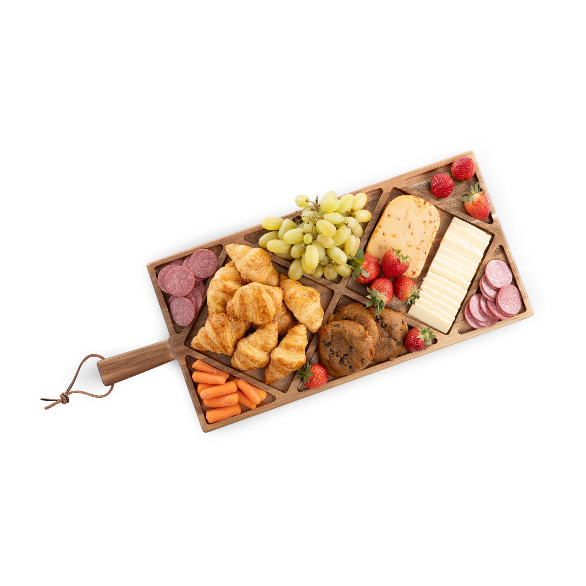 Wooden charcuterie board with assorted foods including cheese, fruits, and meats on a white background