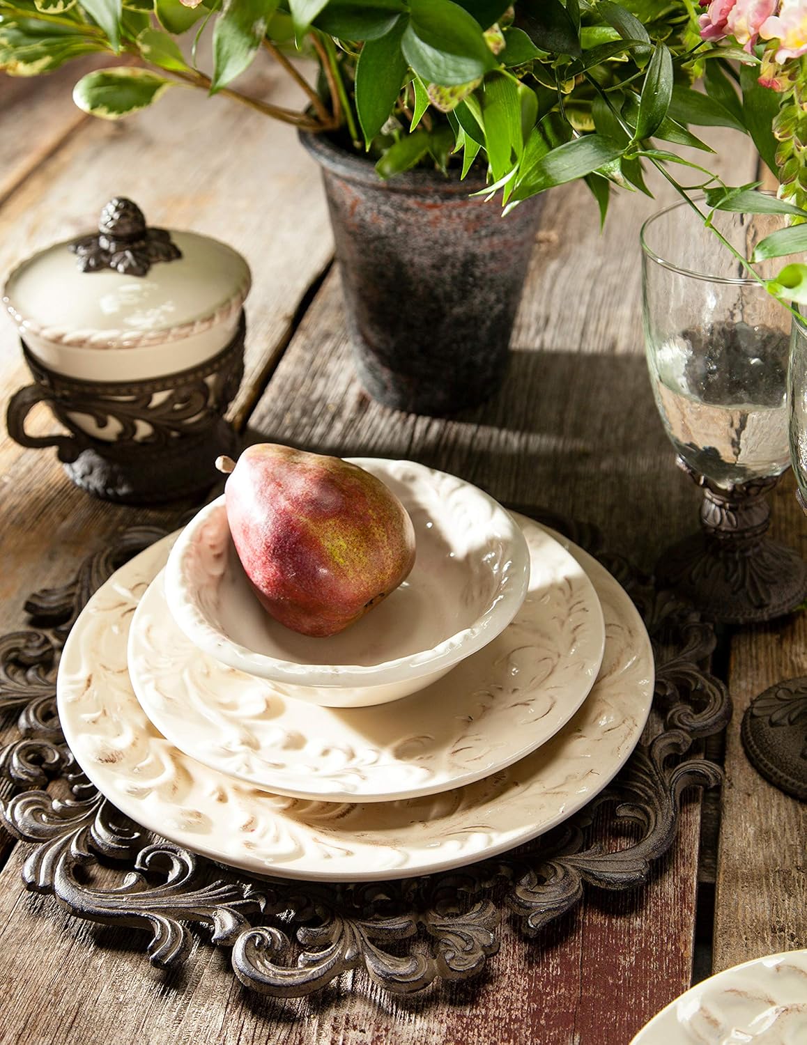 Acanthus Stoneware Dessert Bowls, Set of 4, Decorative table setting with fruit, plates, and a plant on a wooden surface.