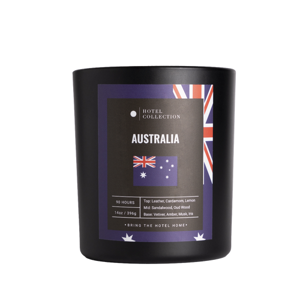Black candle with Australia-themed label on a white background