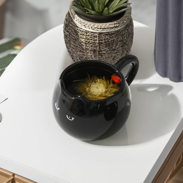 Adorable hand - painted cat - shaped ceramic mug, perfect for coffee or tea.