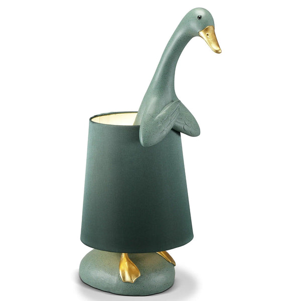 Green swan-shaped lamp on a white background