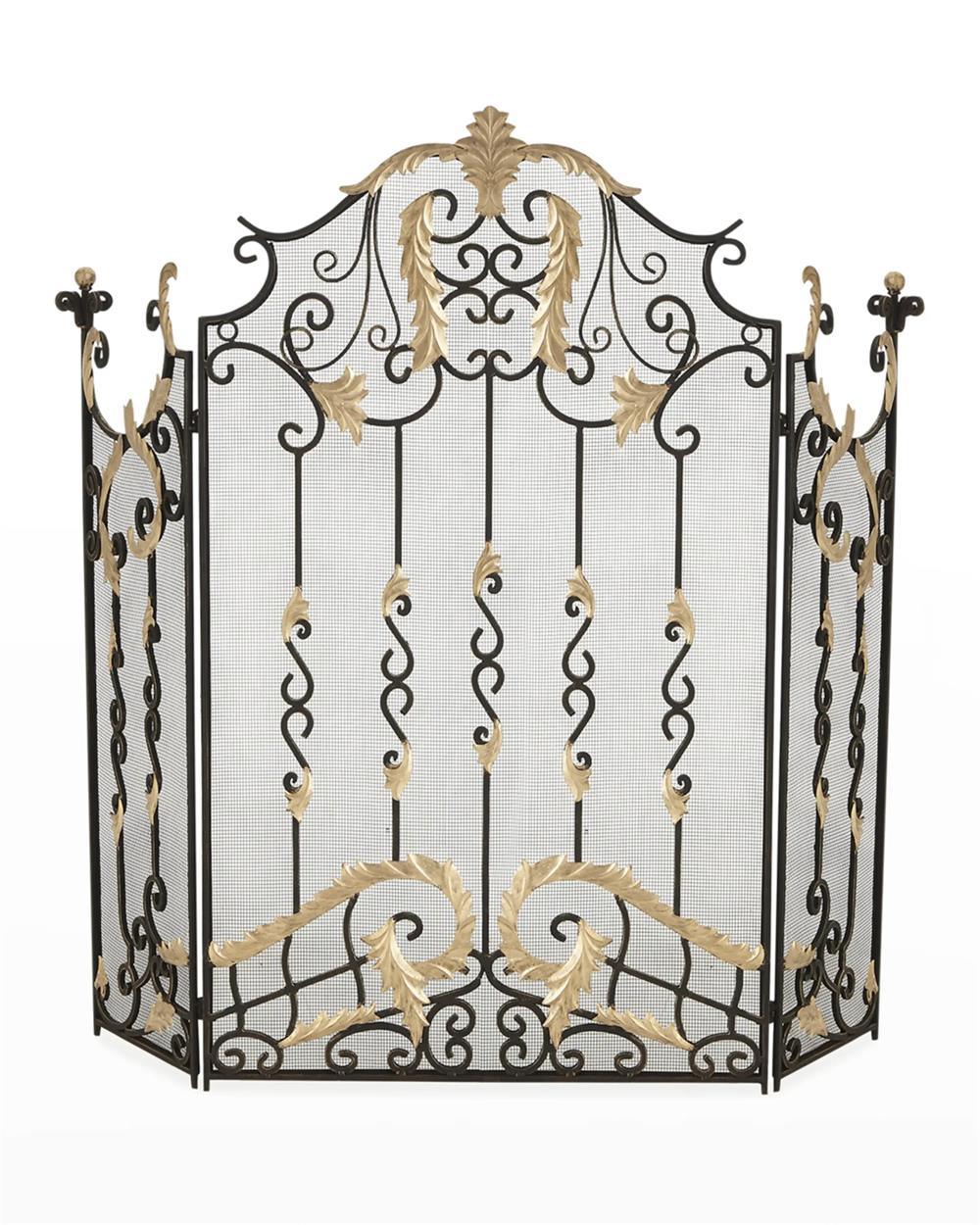 Decorative fireplace screen with intricate gold and black design on a white background