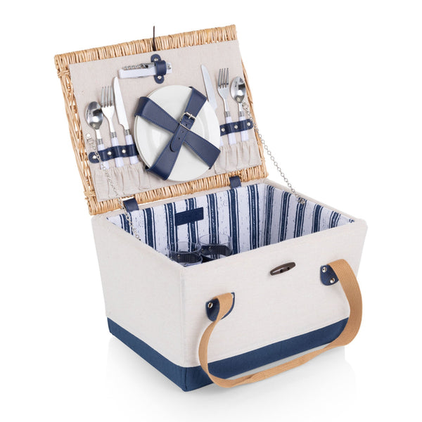 Open picnic basket with cutlery, plates, and napkins on a white background