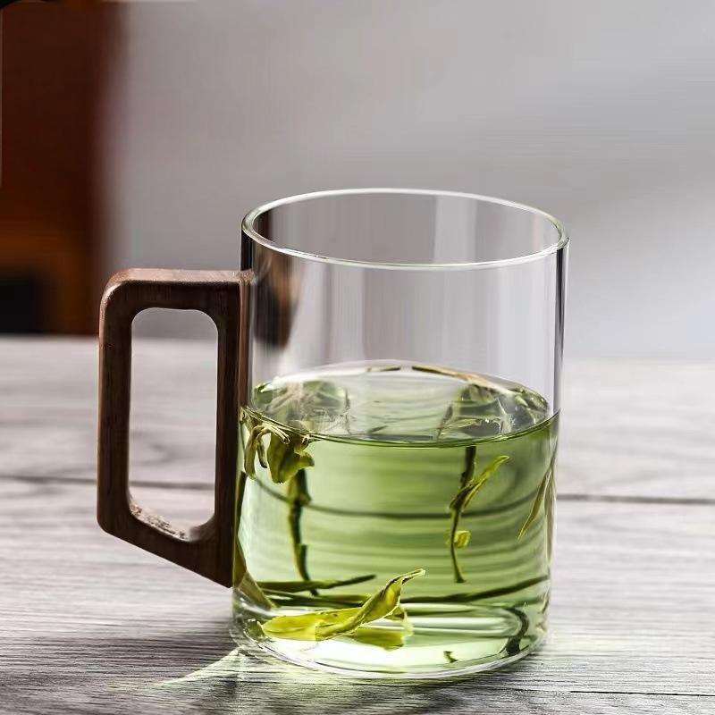 High end green tea cup with walnut handle and lid. High temperature resistant glass office drinking cup