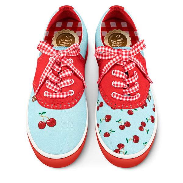 Hot Chocolate Design Red and blue sneakers with cherry pattern and checkered laces on a white background