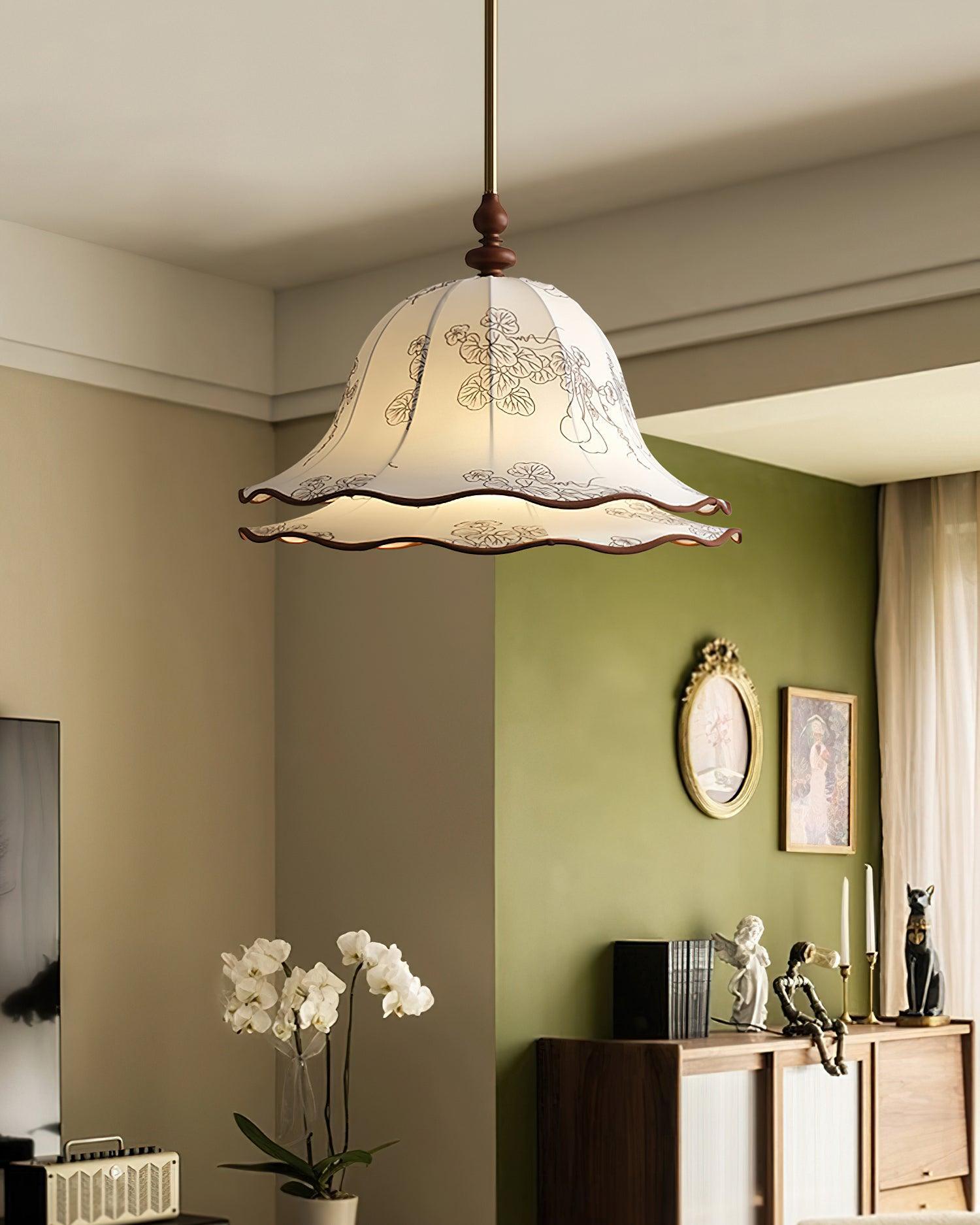 Pendant light fixture in a room with green walls and decorative items.