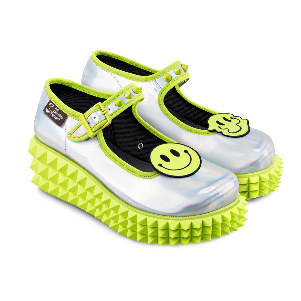 Chocolaticas® Rave Women's Mary Jane Platform - Pair of white shoes with green spikes and smiley face design on a white background