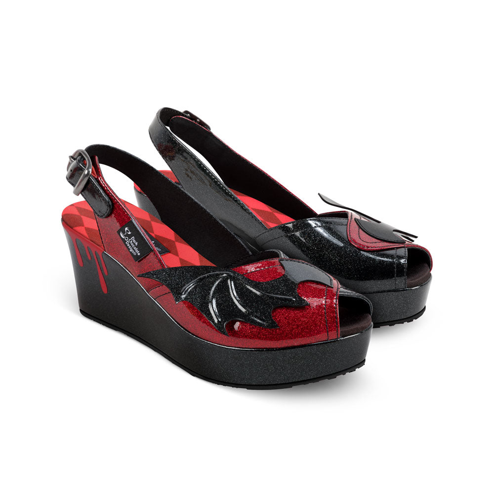 Chocolaticas® Scarlet Women's Sandal - Black and red platform shoes with bat wing design on a white background