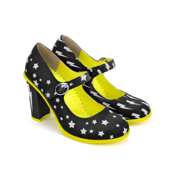 Chocolaticas® High Heels Storm Women's Mary Jane Pump - Black high-heeled shoes with white star patterns and yellow accents on a white background