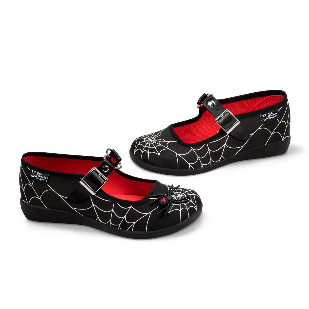 Black shoes with spider web design and red interior on a white background