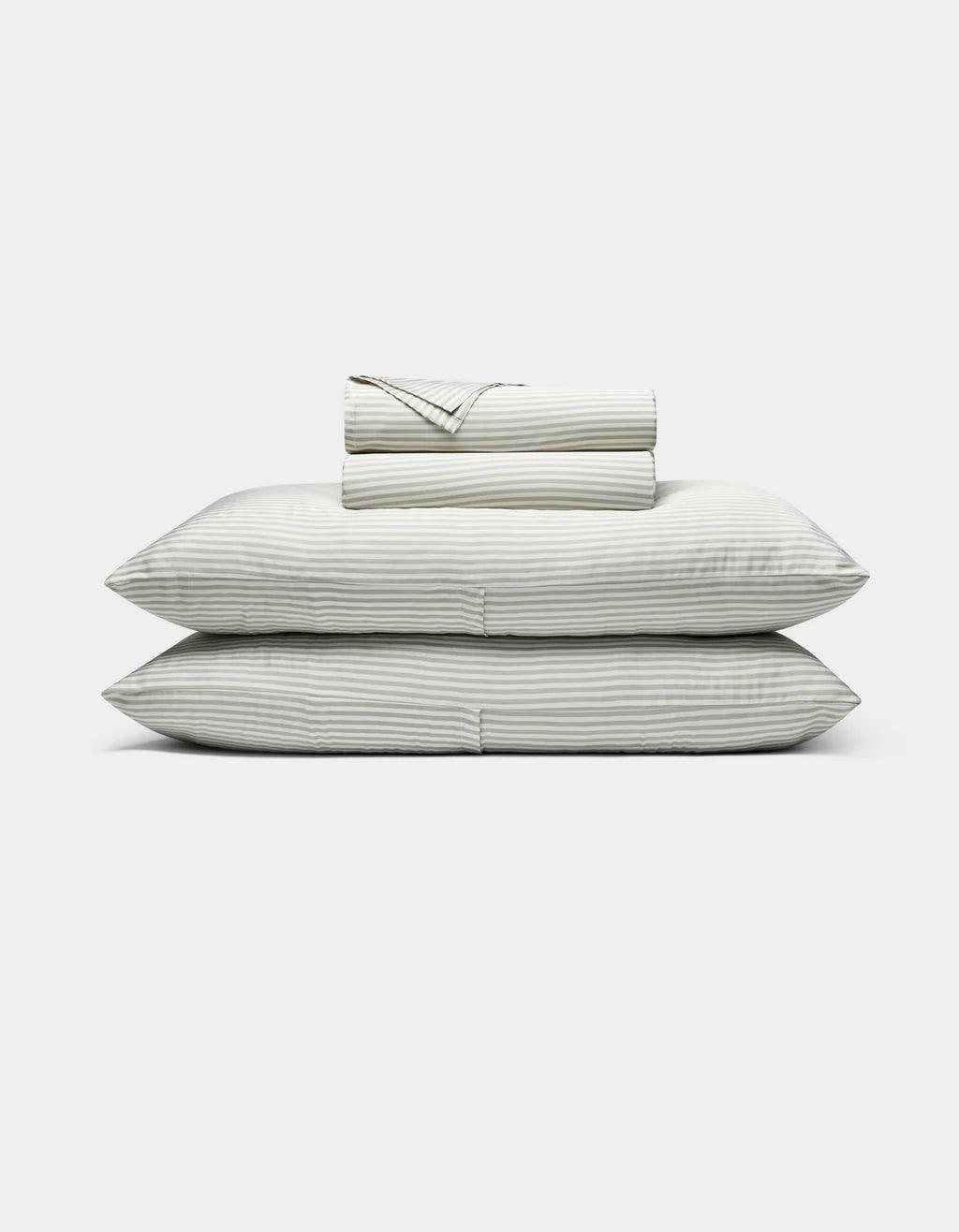 Classic Stripe in Laurel - Set of striped bedding including a duvet, two pillows, and a folded blanket on a white background