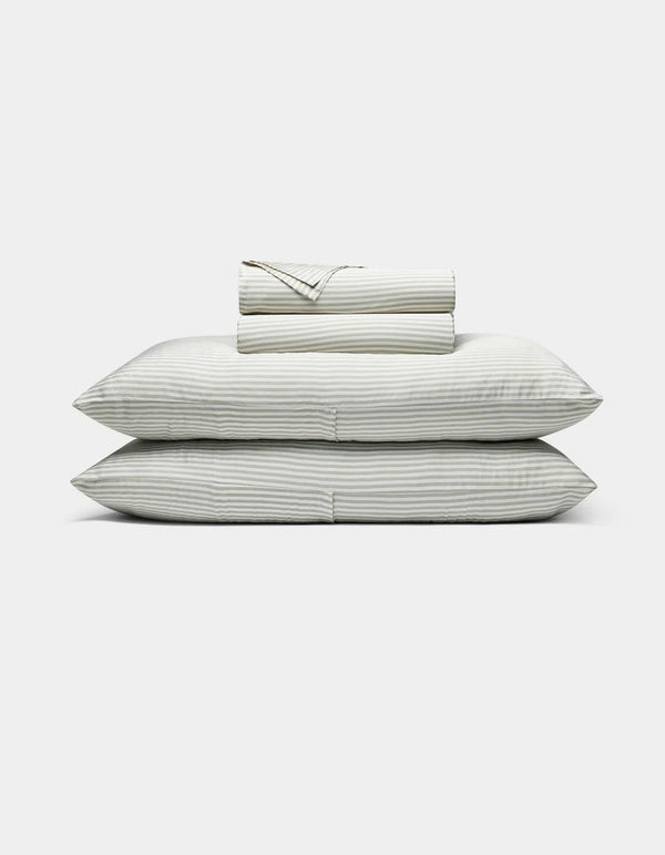 Classic Stripe in Laurel - Set of striped bedding including a duvet, two pillows, and a folded blanket on a white background