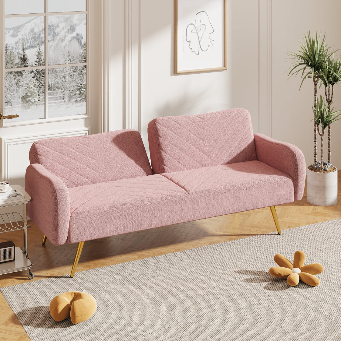 Pink sofa in a room with a window, plant, and decorative items.