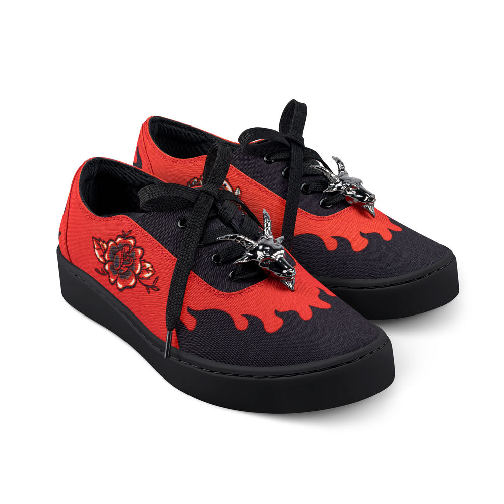 Red and black sneakers with floral design and chain details on a white background