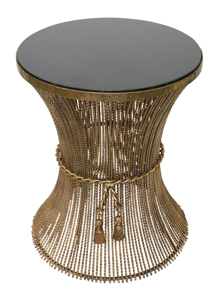 Decorative side table with beaded base and black top on a white background