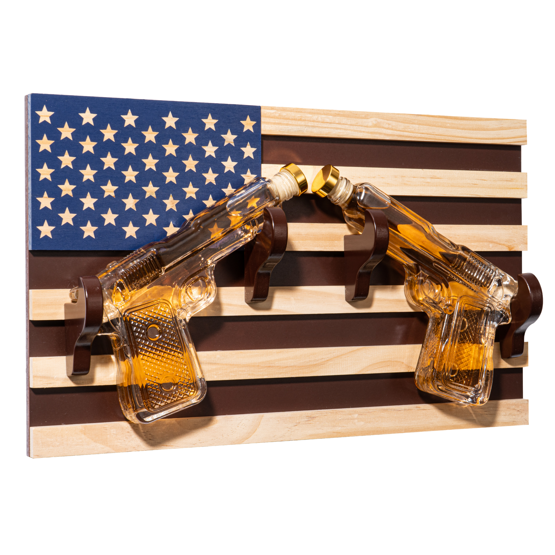 Two glass gun-shaped shot glasses on a wooden plaque with an American flag design.