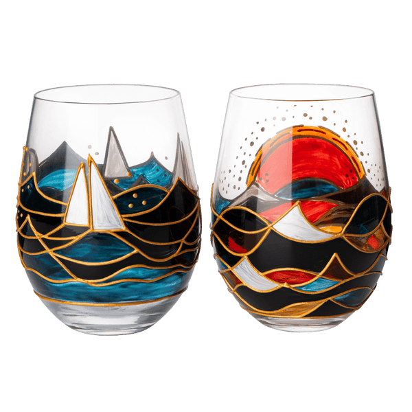 Two artistic wine glasses with scenic designs on a white background