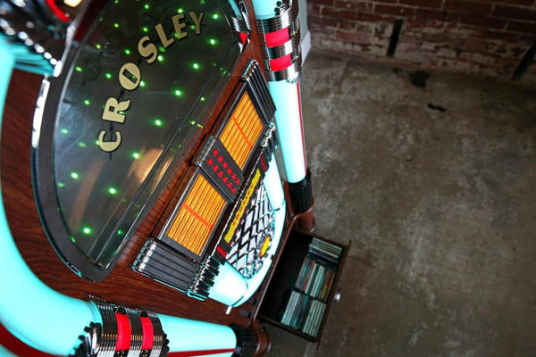 Digital LED Jukebox with Bluetooth - Walnut
CR1215A-WA Close-up of a Crosley record player with a brick wall background