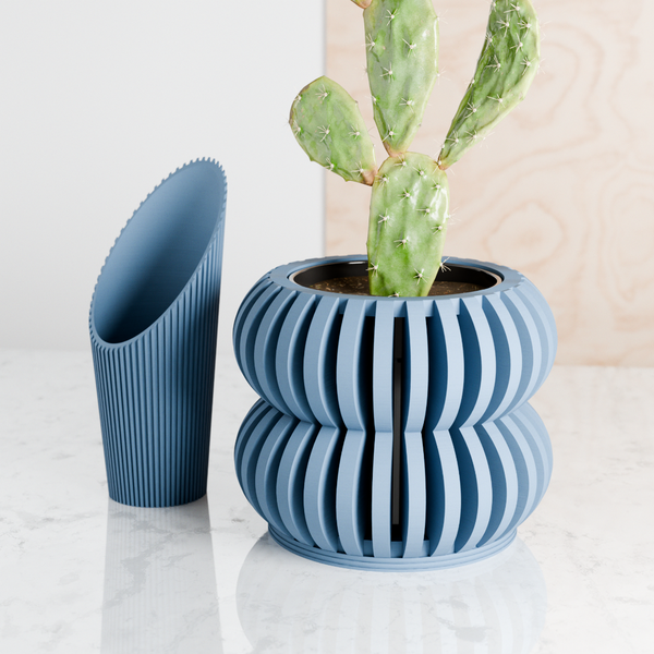 Blue ribbed plant pot with a cactus on a light surface