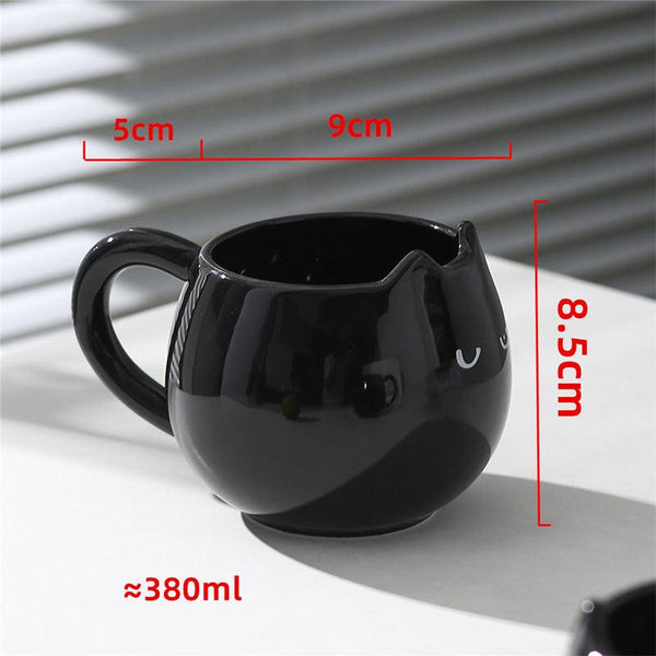 Adorable hand - painted cat - shaped ceramic mug, perfect for coffee or tea.