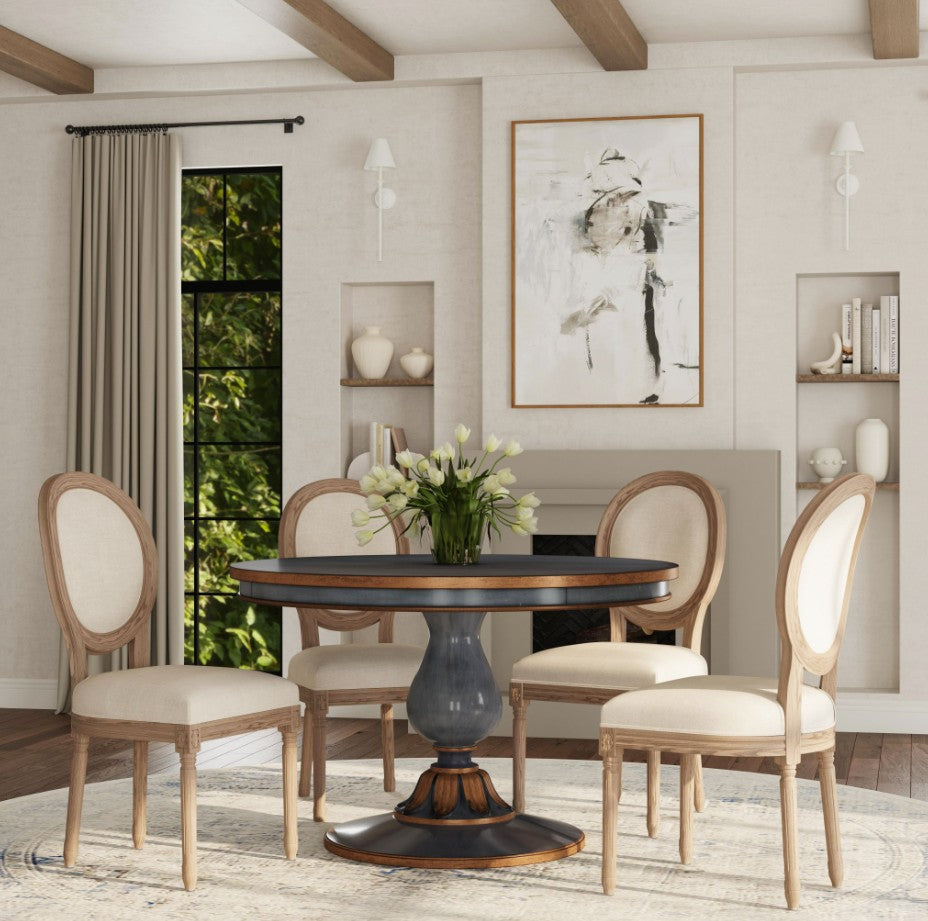 Dining room with round table and chairs in a stylishly decorated room.