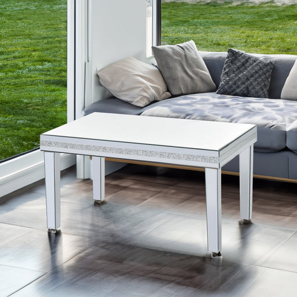 The ON-TRANS stylish modern glass mirrored coffee table features a crystal design and adjustable height legs in silver
