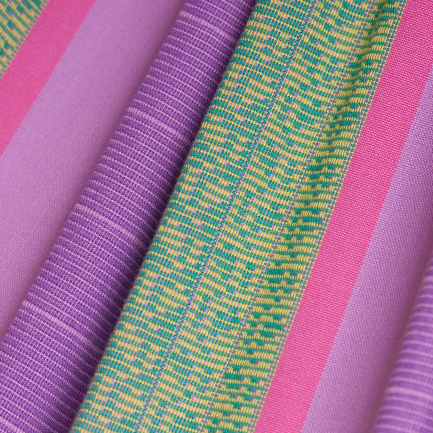 Close-up of colorful fabric with pink, purple, and green stripes.