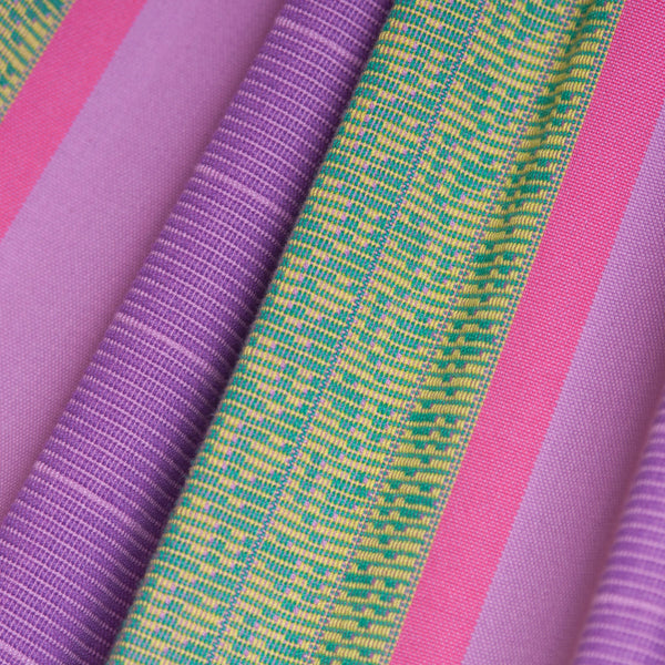 Close-up of colorful fabric with pink, purple, and green stripes.