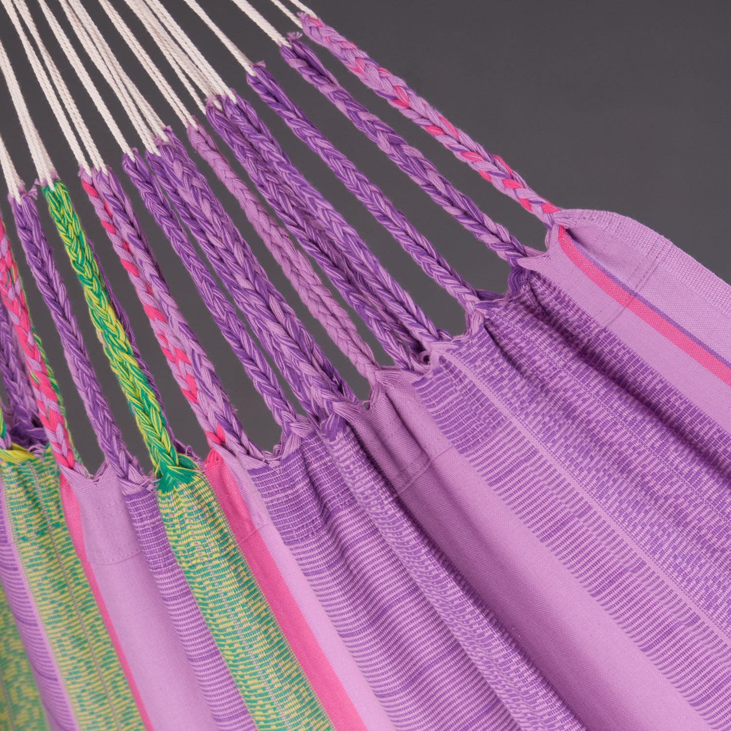 Close-up of a colorful hammock with purple straps on a gray background