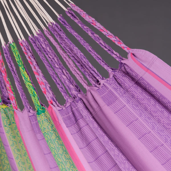Close-up of a colorful hammock with purple straps on a gray background