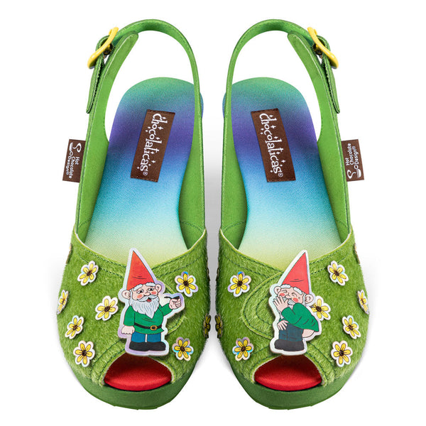Green sandals with gnome designs and colorful soles on a white background