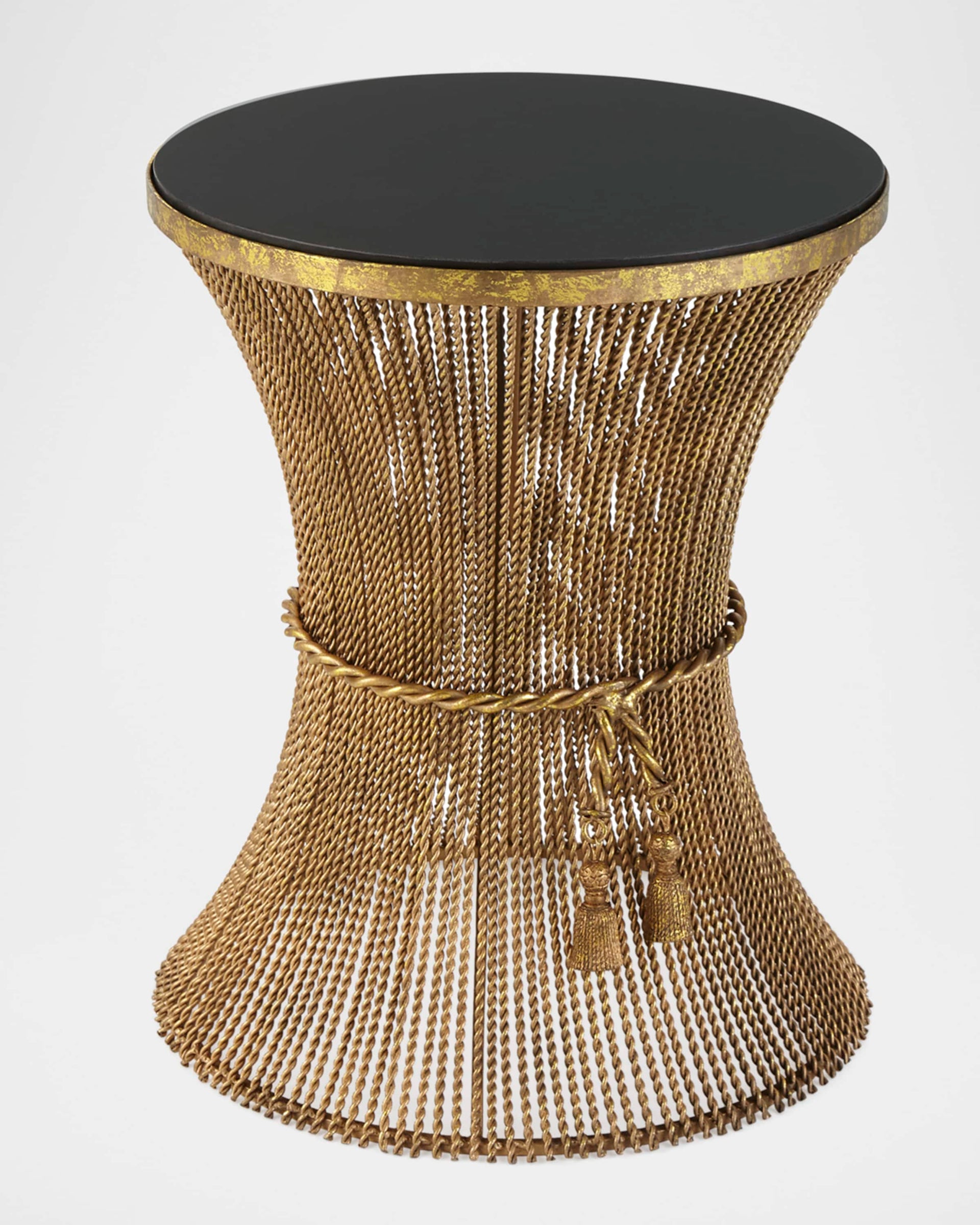 Decorative side table with gold chain design and black top on a white background