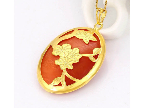 Oval shaped rust-red color noble charms pendant with gold flowers