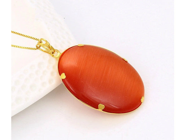 Oval shaped rust-red color noble charms pendant with gold flowers