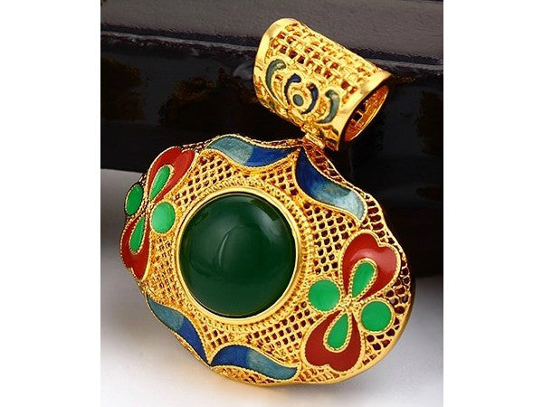 Leaf shaped gold pendant with green and red enamel work