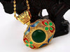 Leaf shaped gold pendant with green and red enamel work