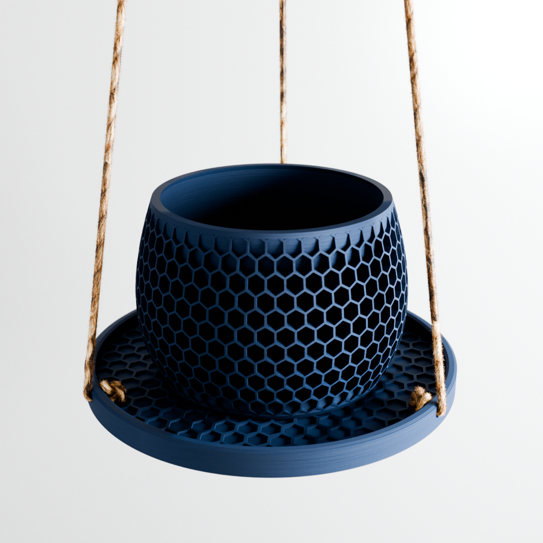 Blue hanging planter with honeycomb pattern on a white background