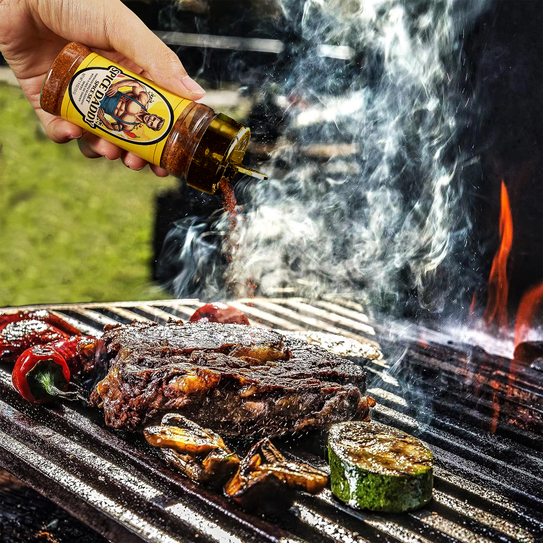 Person pouring barbecue sauce onto grilled meat and vegetables on a grill