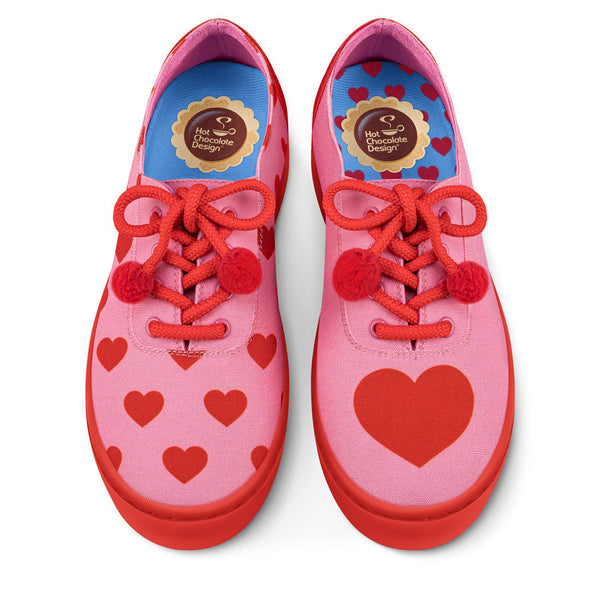 Hot Chocolate Design Pink shoes with red hearts and red laces on a white background