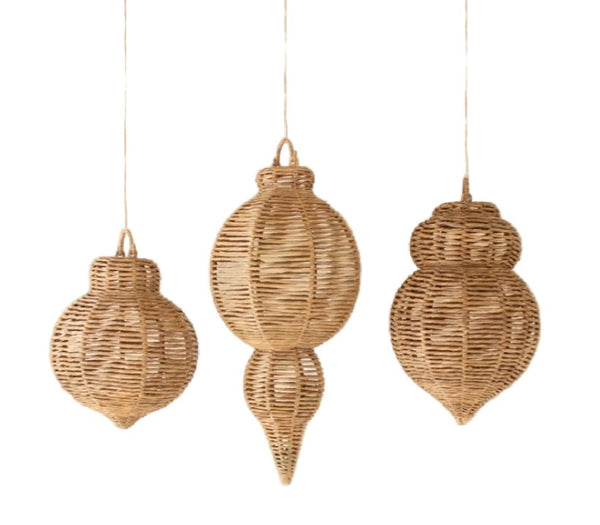Three woven rattan ornaments hanging against a white background