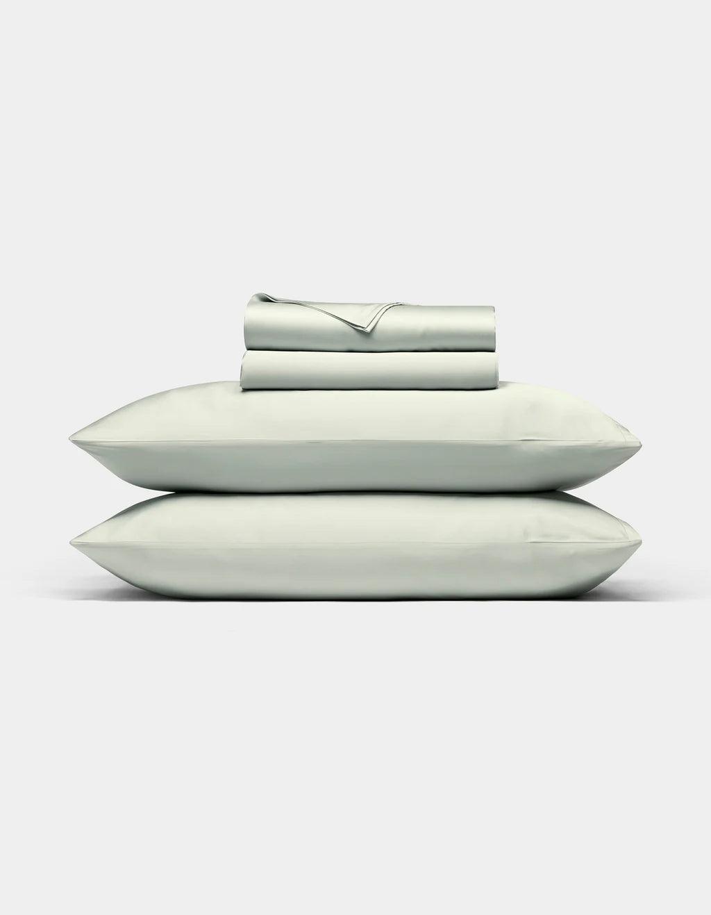Laurel bedding including a duvet, two pillows, and a folded blanket on a white background