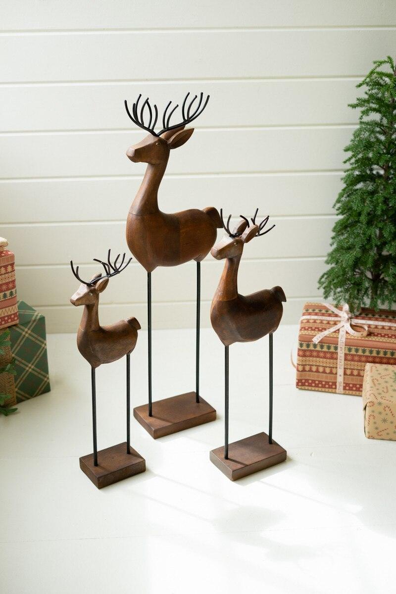 SET OF THREE CARVED WOOD AND IRON REINDEER ON BASES