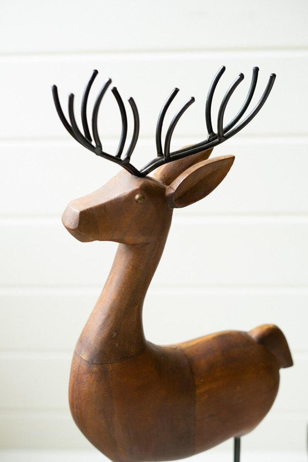 SET OF THREE CARVED WOOD AND IRON REINDEER ON BASES