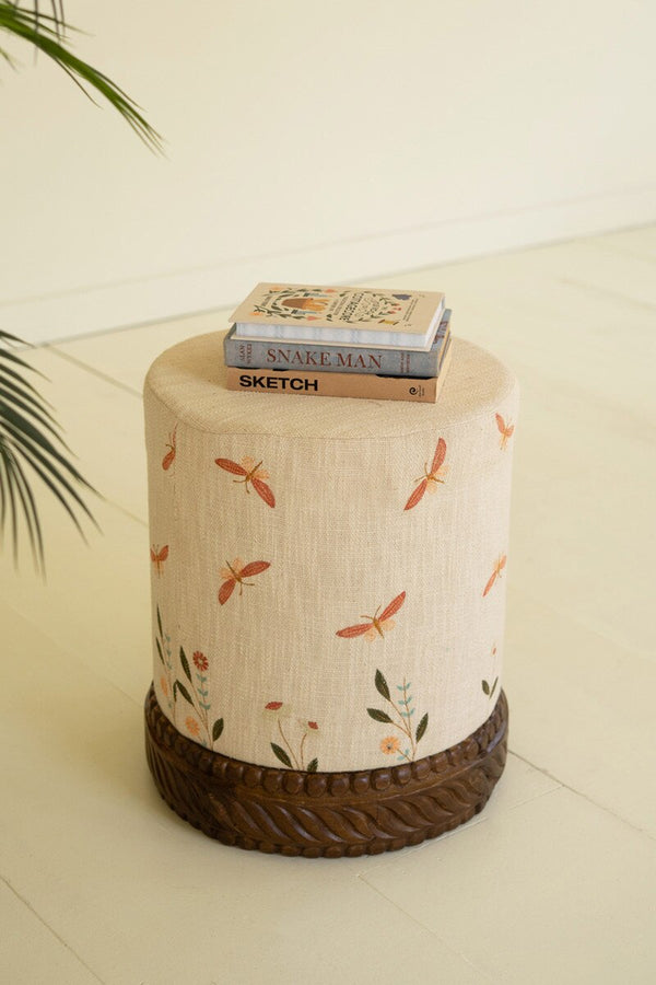 UPHOLSTERED OTTOMAN WITH CARVED WOOD BASE - CREAM
