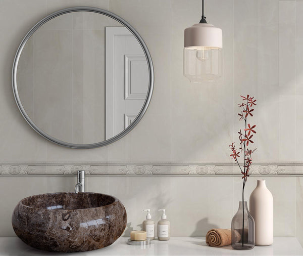 Bathroom with round mirror, sink, and decorative elements.
